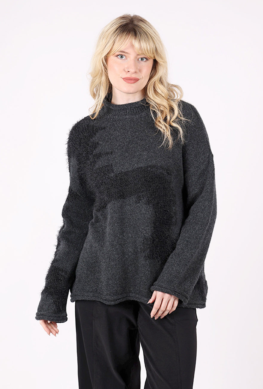 Woman wearing a dark gray sweater on a white background